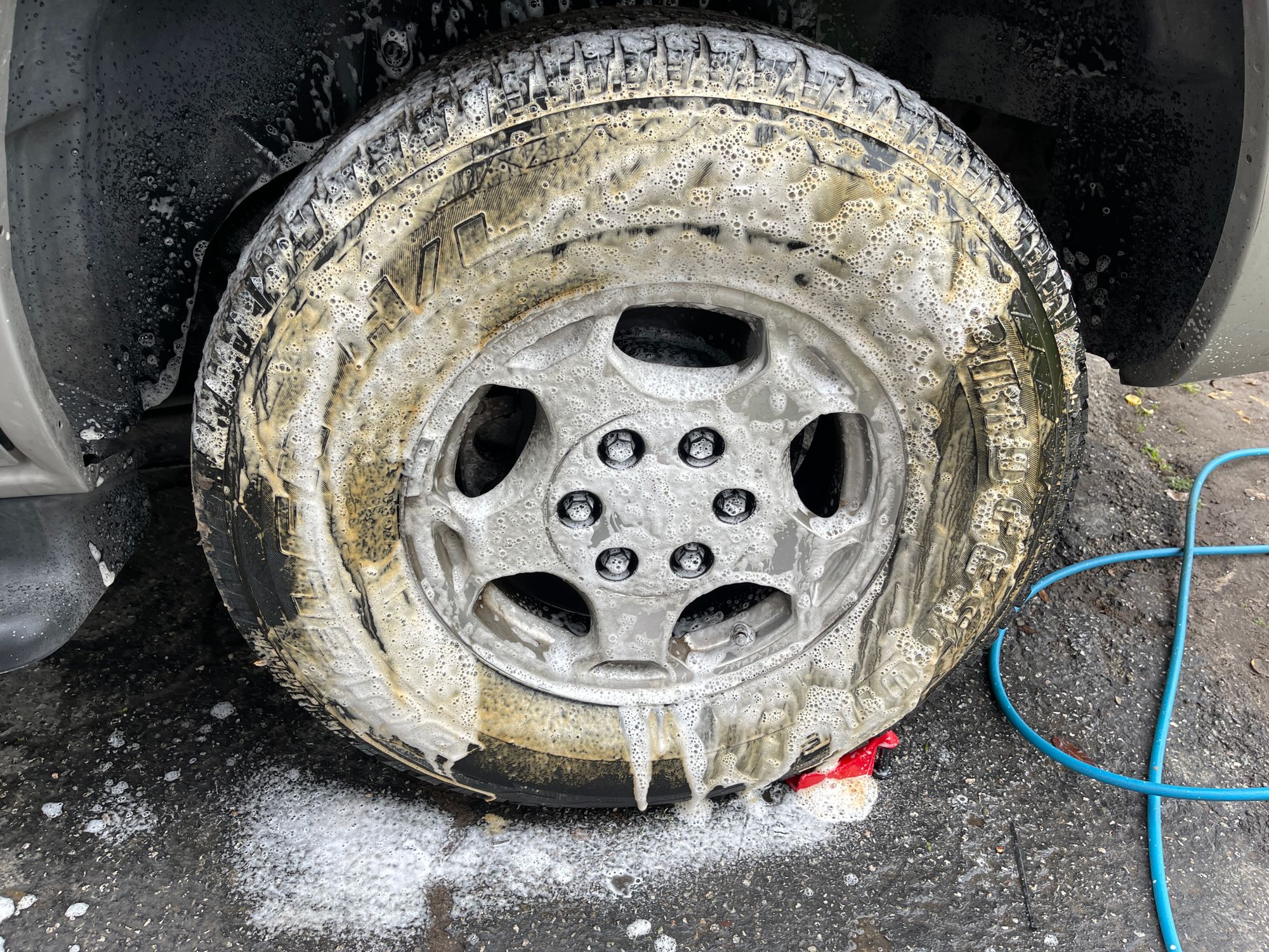 A vehicle wheel covered with cleaning foam